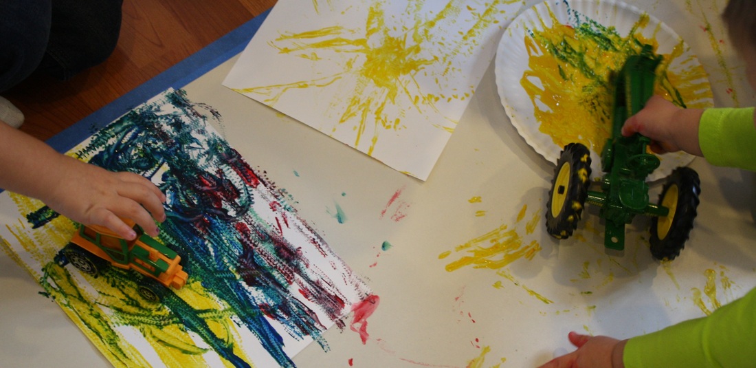 Painting with tractor tracks -- Hilary's Home Daycare & Preschool